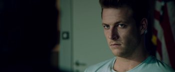 Movie still from “The November Man” (2014), directed by Roger Donaldson – A person looking at the camera; Close Up shot, Over the shoulder angle