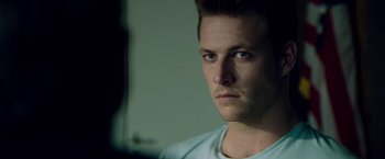Movie still from “The November Man” (2014), directed by Roger Donaldson – A person looking at the camera; Close Up shot, Over the shoulder angle