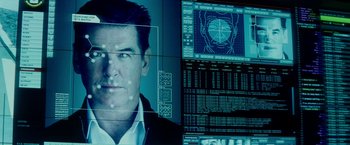 Movie still from “The November Man” (2014), directed by Roger Donaldson – A computer screen showing a man's face and a computer screen showing a person's face; Close Up shot, Over the shoulder angle