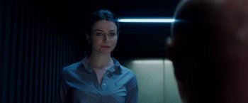 Movie still from “The November Man” (2014), directed by Roger Donaldson – A woman standing in front of a mirror in a dark room; Close Up shot, Over the shoulder angle