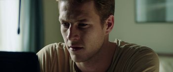 Movie still from “The November Man” (2014), directed by Roger Donaldson – A man's face in a tan shirt; Close Up shot, Low angle