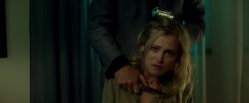 Movie still from “The November Man” (2014), directed by Roger Donaldson – A man holding a knife over a woman's neck; Close Up shot, Over the shoulder angle