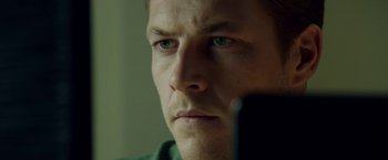 Movie still from “The November Man” (2014), directed by Roger Donaldson – A person with a cell phone; Close Up shot, Low angle