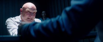 Movie still from “The November Man” (2014), directed by Roger Donaldson – A man and a woman in a dark room; Close Up shot, Over the shoulder angle