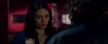 Movie still from “The November Man” (2014), directed by Roger Donaldson – A woman looking into a mirror while standing up; Close Up shot, Over the shoulder angle