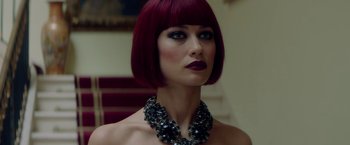 Movie still from “The November Man” (2014), directed by Roger Donaldson – A woman with red hair wearing a necklace; Close Up shot, Over the shoulder angle