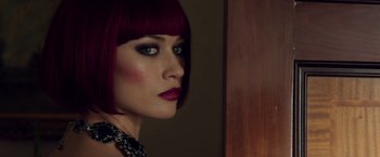 Movie still from “The November Man” (2014), directed by Roger Donaldson – A person wearing a red wig; Close Up shot, Over the shoulder angle