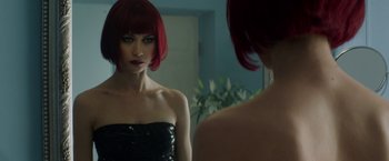 Movie still from “The November Man” (2014), directed by Roger Donaldson – A woman with red hair looking into a mirror; Close Up shot, Over the shoulder angle