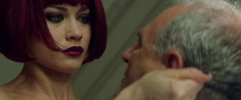 Movie still from “The November Man” (2014), directed by Roger Donaldson – A woman with red hair looking at an older man's face; Close Up shot, Over the shoulder angle