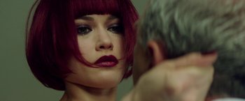 Movie still from “The November Man” (2014), directed by Roger Donaldson – A person with red hair looking at a mirror; Close Up shot, Over the shoulder angle