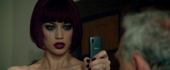 Movie still from “The November Man” (2014), directed by Roger Donaldson – A woman taking a picture of herself with a cell phone; Close Up shot, Over the shoulder angle