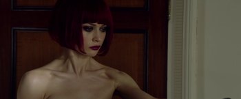 Movie still from “The November Man” (2014), directed by Roger Donaldson – A woman with red hair is looking into a mirror; Close Up shot, Low angle