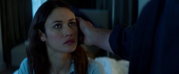 Movie still from “The November Man” (2014), directed by Roger Donaldson – A woman getting her hair combed by a man; Close Up shot, Over the shoulder angle