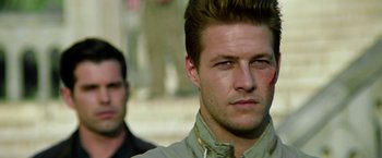 Movie still from “The November Man” (2014), directed by Roger Donaldson – A person with a bandage on his face; Close Up shot, Over the shoulder angle