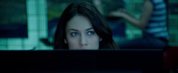 Movie still from “The November Man” (2014), directed by Roger Donaldson – A woman looking at a computer screen with blue eyes; Close Up shot, Over the shoulder angle