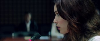 Movie still from “The November Man” (2014), directed by Roger Donaldson – A person holding a microphone; Close Up shot, Over the shoulder angle