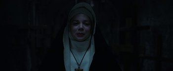 Movie still from “The Nun” (2018), directed by Corin Hardy – A woman wearing a nun's outfit in the dark; Close Up shot, Low angle