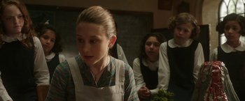 Movie still from “The Nun” (2018), directed by Corin Hardy – A group of young people sitting in front of a chalkboard; Close Up shot, Over the shoulder angle