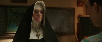 Movie still from “The Nun” (2018), directed by Corin Hardy – An older woman wearing glasses and a nun's outfit; Close Up shot, Low angle