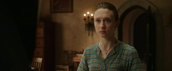 Movie still from “The Nun” (2018), directed by Corin Hardy – A woman in a green plaid shirt looking at the camera; Close Up shot, Over the shoulder angle