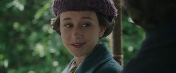 Movie still from “The Nun” (2018), directed by Corin Hardy – A young woman wearing a purple knitted hat; Close Up shot, Over the shoulder angle