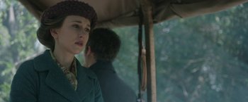 Movie still from “The Nun” (2018), directed by Corin Hardy – A woman in a green coat and a man in a brown hat; Close Up shot, Over the shoulder angle