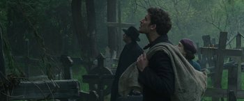 Movie still from “The Nun” (2018), directed by Corin Hardy – A man in a black coat and a man in a black hat; Medium shot, Low angle