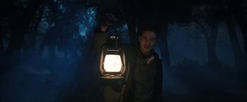 Movie still from “The Nun” (2018), directed by Corin Hardy – A man holding a lantern in the dark; Medium shot, Low angle