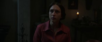 Movie still from “The Nun” (2018), directed by Corin Hardy – A woman in a red shirt is looking at the camera; Close Up shot, Over the shoulder angle