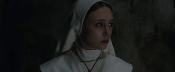 Movie still from “The Nun” (2018), directed by Corin Hardy – A woman wearing a white robe and a white head covering; Close Up shot, Low angle