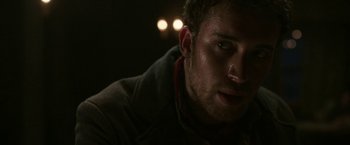 Movie still from “The Nun” (2018), directed by Corin Hardy – A man's face in the dark; Close Up shot, Over the shoulder angle