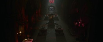 Movie still from “The Nun” (2018), directed by Corin Hardy – A dark room with a cross on the wall; Extreme Wide shot, High angle