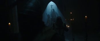 Movie still from “The Nun” (2018), directed by Corin Hardy – A group of people standing inside of a building; Wide shot, Low angle