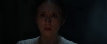Movie still from “The Nun” (2018), directed by Corin Hardy – A young girl is looking into the camera; Close Up shot, High angle