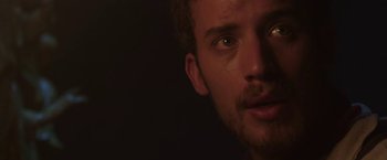 Movie still from “The Nun” (2018), directed by Corin Hardy – A man's face in the dark; Close Up shot, Over the shoulder angle