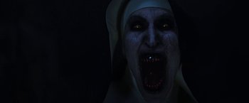 Movie still from “The Nun” (2018), directed by Corin Hardy – A woman with a nun's head and face is screaming; Close Up shot, Overhead angle