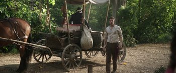 Movie still from “The Nun” (2018), directed by Corin Hardy – A man standing in front of a horse drawn carriage; Wide shot, Low angle