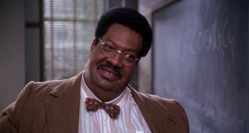 Movie still from “The Nutty Professor” (1996), directed by Tom Shadyac – A person wearing glasses and a bow tie; Close Up shot, Low angle
