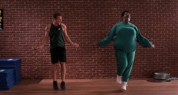 Movie still from “The Nutty Professor” (1996), directed by Tom Shadyac – A man and a woman are dancing on a stage; Wide shot, Low angle