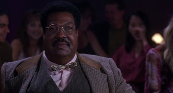 Movie still from “The Nutty Professor” (1996), directed by Tom Shadyac – A person wearing glasses and a bow tie; Close Up shot, Low angle