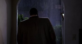 Movie still from “The Nutty Professor” (1996), directed by Tom Shadyac – A man walking in the rain at night; Medium shot, Low angle