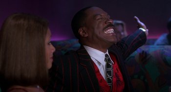 Movie still from “The Nutty Professor” (1996), directed by Tom Shadyac – A man and a woman are laughing together; Medium shot, Low angle