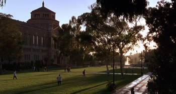 Movie still from “The Nutty Professor” (1996), directed by Tom Shadyac – A group of people playing frisbee in the grass; Extreme Wide shot, High angle