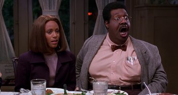 Movie still from “The Nutty Professor” (1996), directed by Tom Shadyac – A man and a woman sitting at a dinner table; Medium shot, Over the shoulder angle