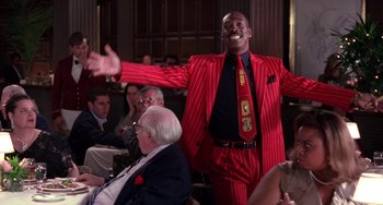 Movie still from “The Nutty Professor” (1996), directed by Tom Shadyac – A man in a red and black striped suit and tie; Medium shot, Low angle