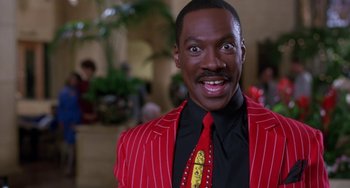 Movie still from “The Nutty Professor” (1996), directed by Tom Shadyac – Eddie murphy in a red suit and a red tie; Close Up shot, Low angle