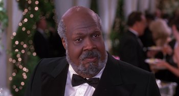 Movie still from “The Nutty Professor” (1996), directed by Tom Shadyac – An older man in a suit and bow tie; Close Up shot, Low angle