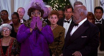 Movie still from “The Nutty Professor” (1996), directed by Tom Shadyac – A group of people standing in a room; Close Up shot, Over the shoulder angle