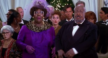 Movie still from “The Nutty Professor” (1996), directed by Tom Shadyac – A group of people standing around each other in formal wear; Close Up shot, Low angle