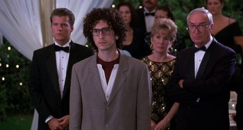 Movie still from “The Nutty Professor” (1996), directed by Tom Shadyac – A group of people standing in a room; Medium shot, Over the shoulder angle